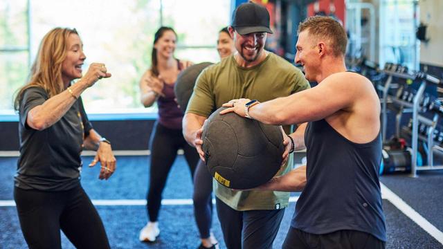 group of people exercising in a small group training class