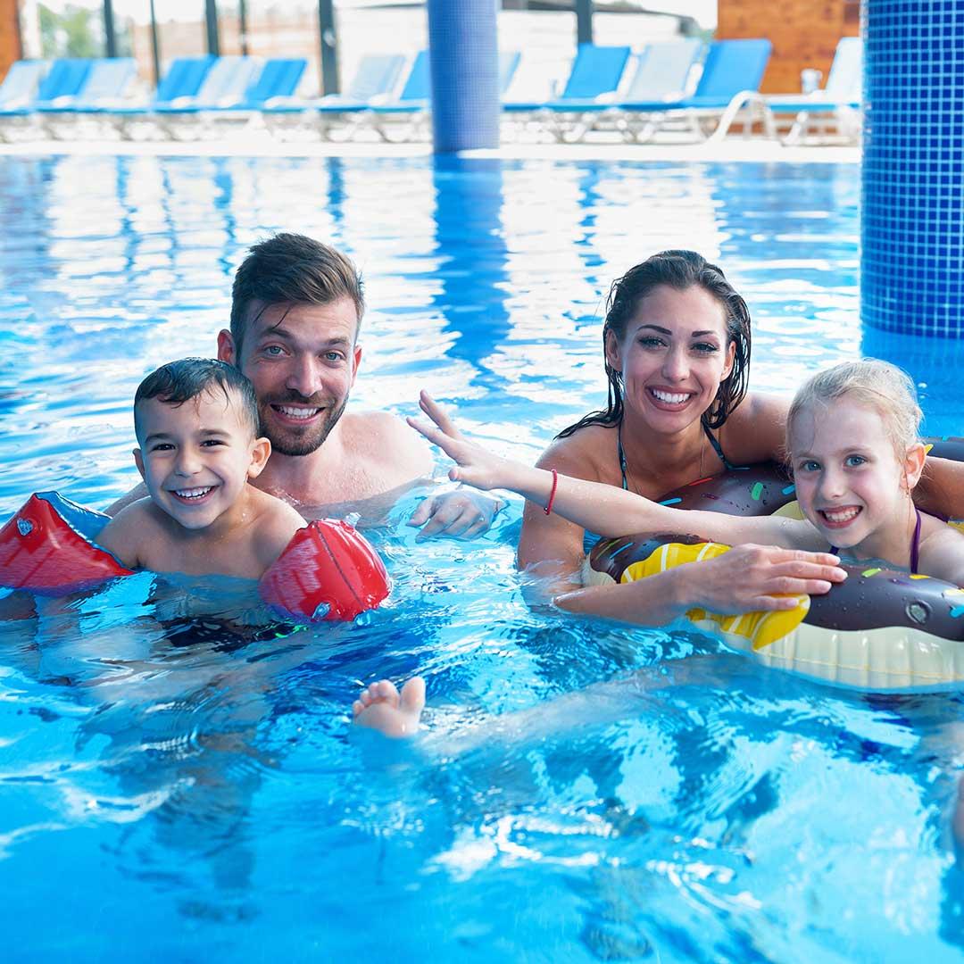 family swimming indoors