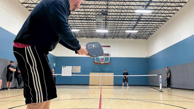 man playing pickleball outdoors