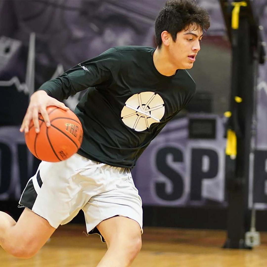 young men laying basketball