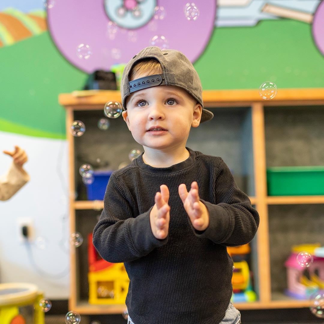 Little boy playing in bubbles
